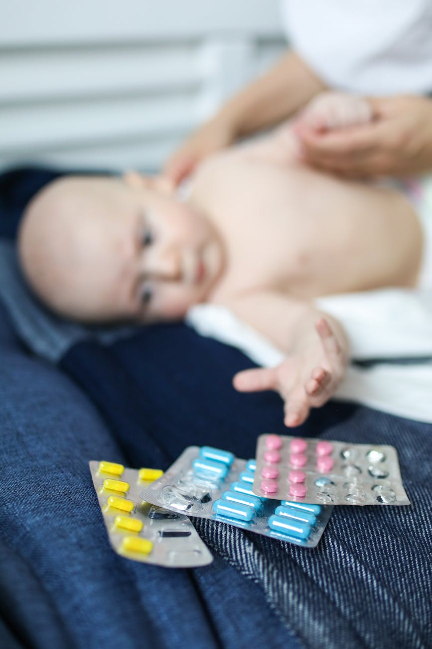 baby reaching for pills