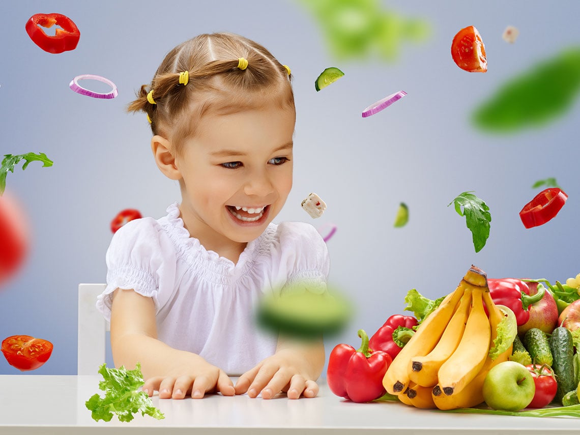 niña rodeada de verduras