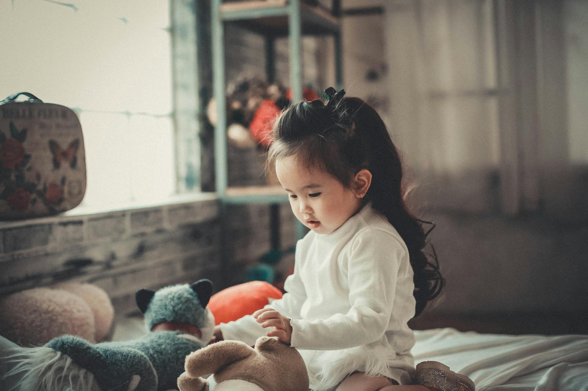 photography of a baby girl playing