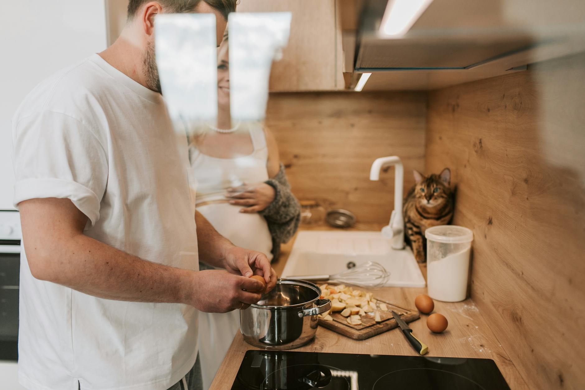 a side view of man cooking in the kitchen