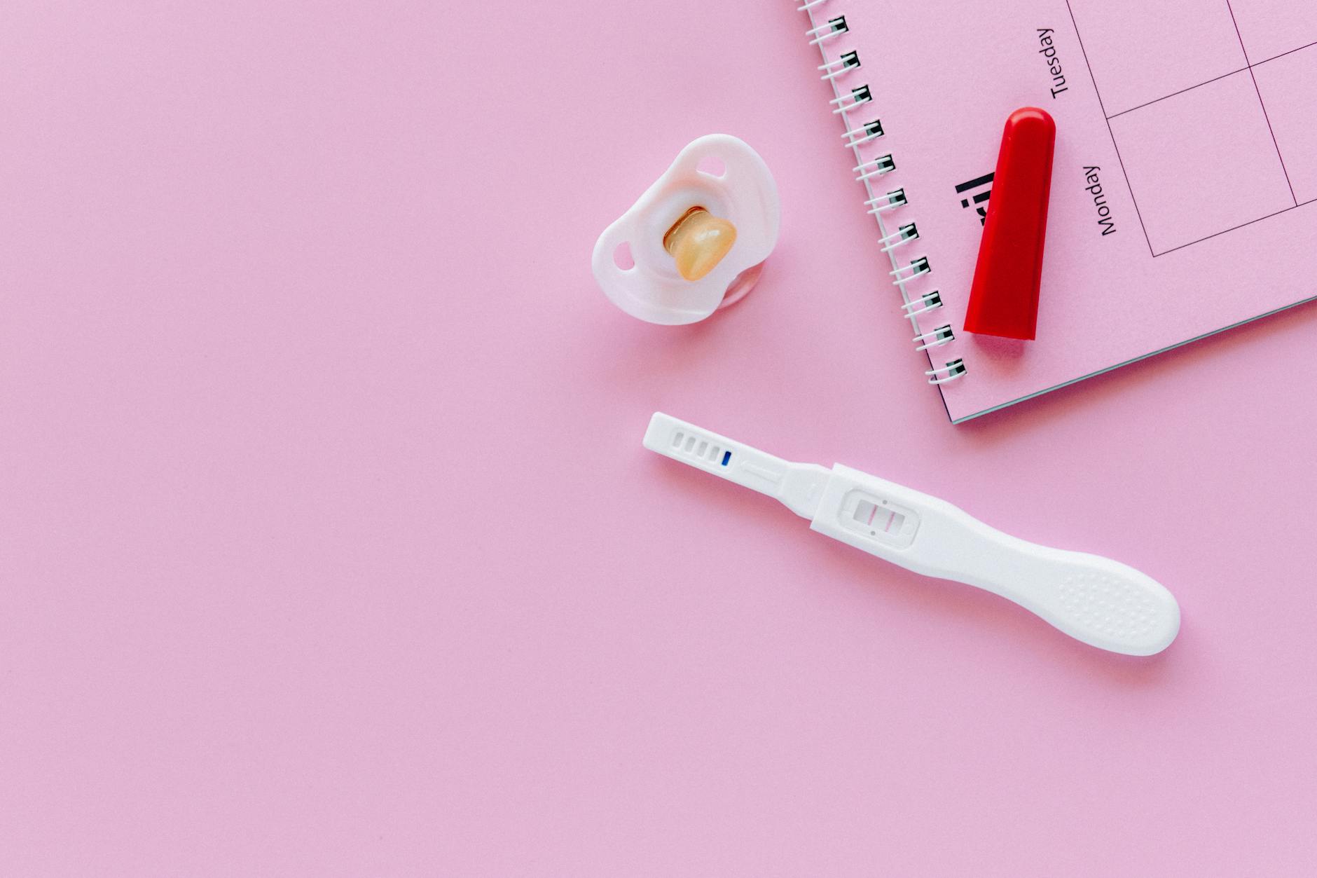 white and pink plastic measuring tool