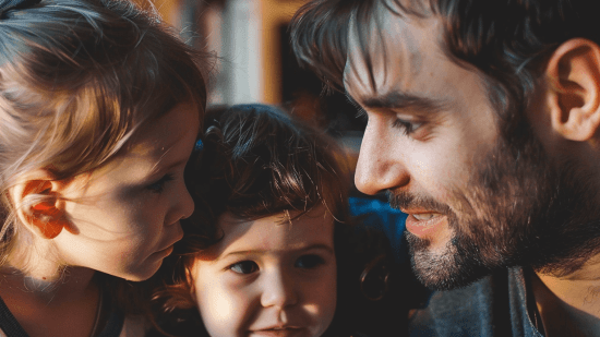 Un padre y sus dos hijas hablando en la intimidad