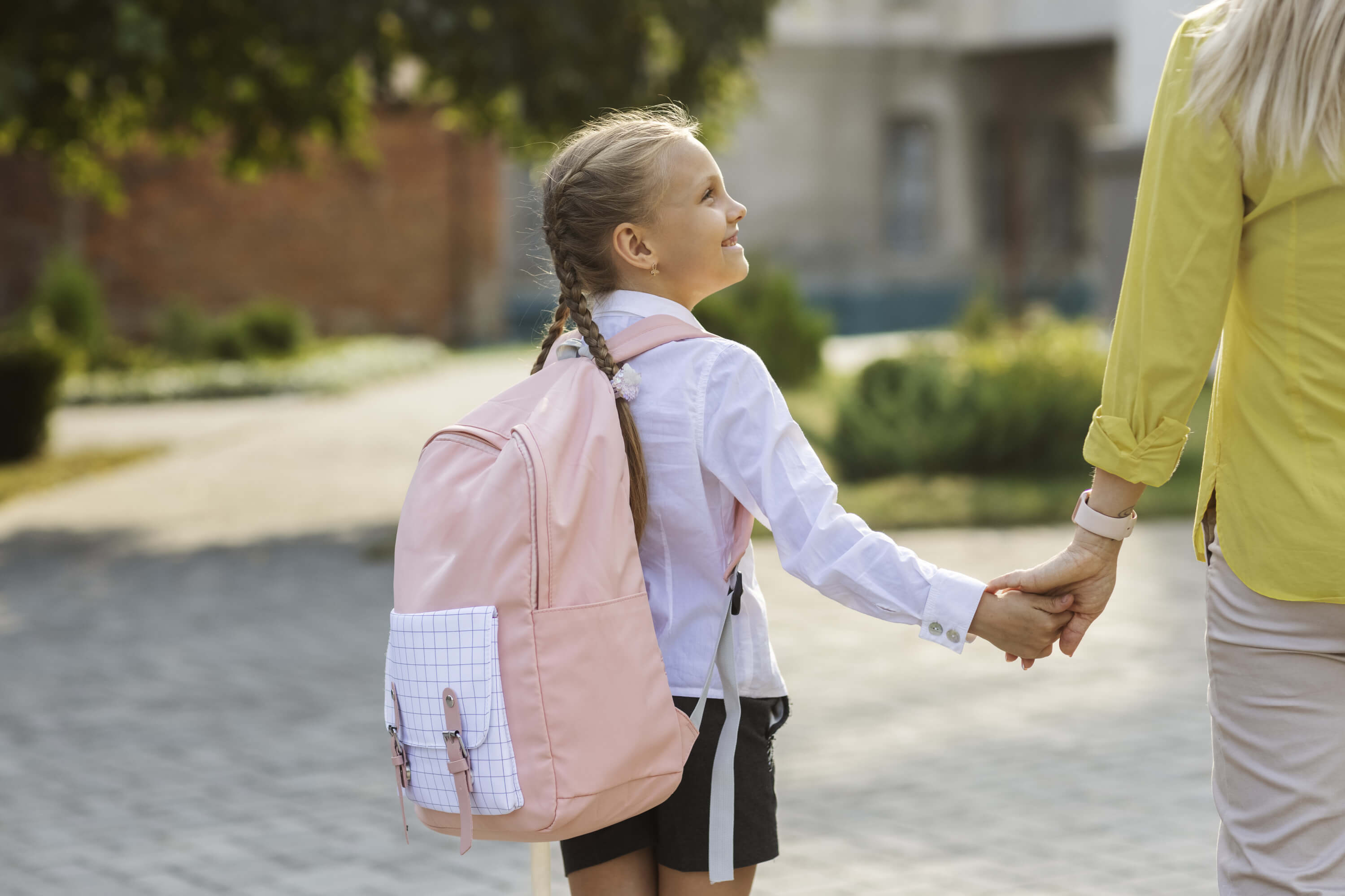 side-view-girl-holding-hands-with-mother