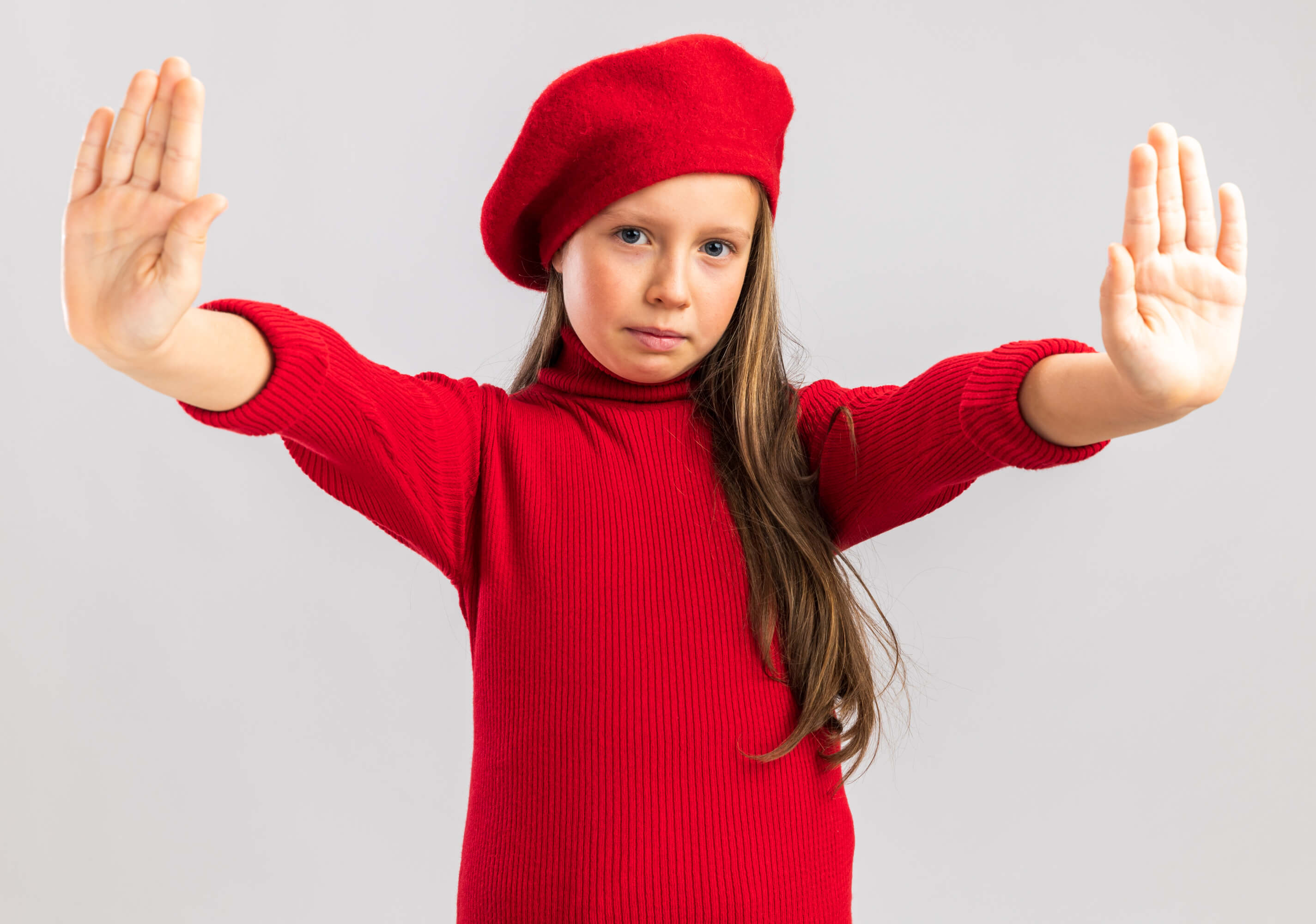serious-little-blonde-girl-wearing-red-beret-showing-stop-gesture-looking-front-isolated-white-wall