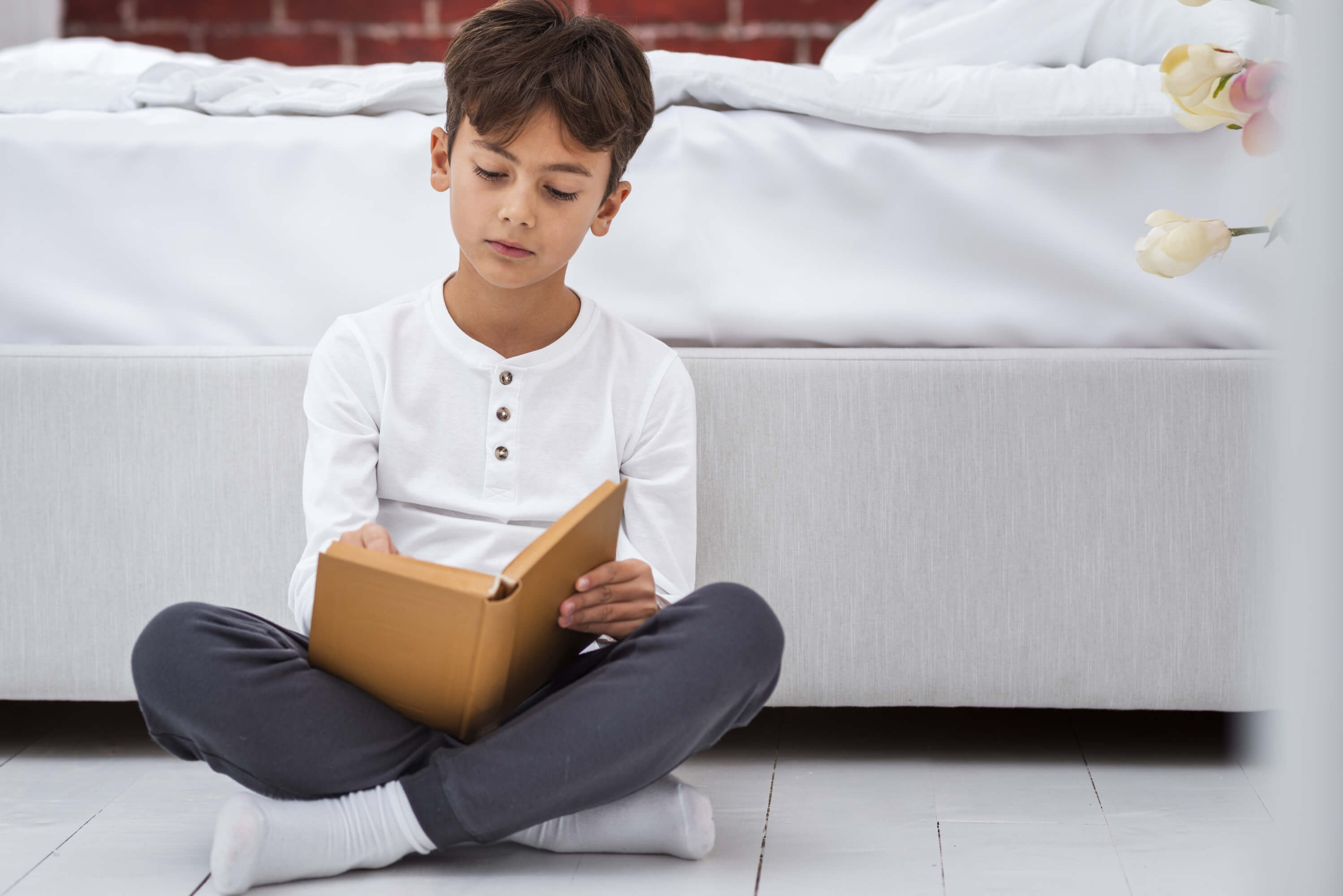 front-view-young-boy-home-reading
