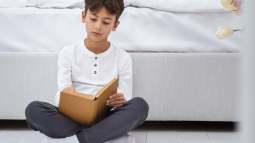 front-view-young-boy-home-reading