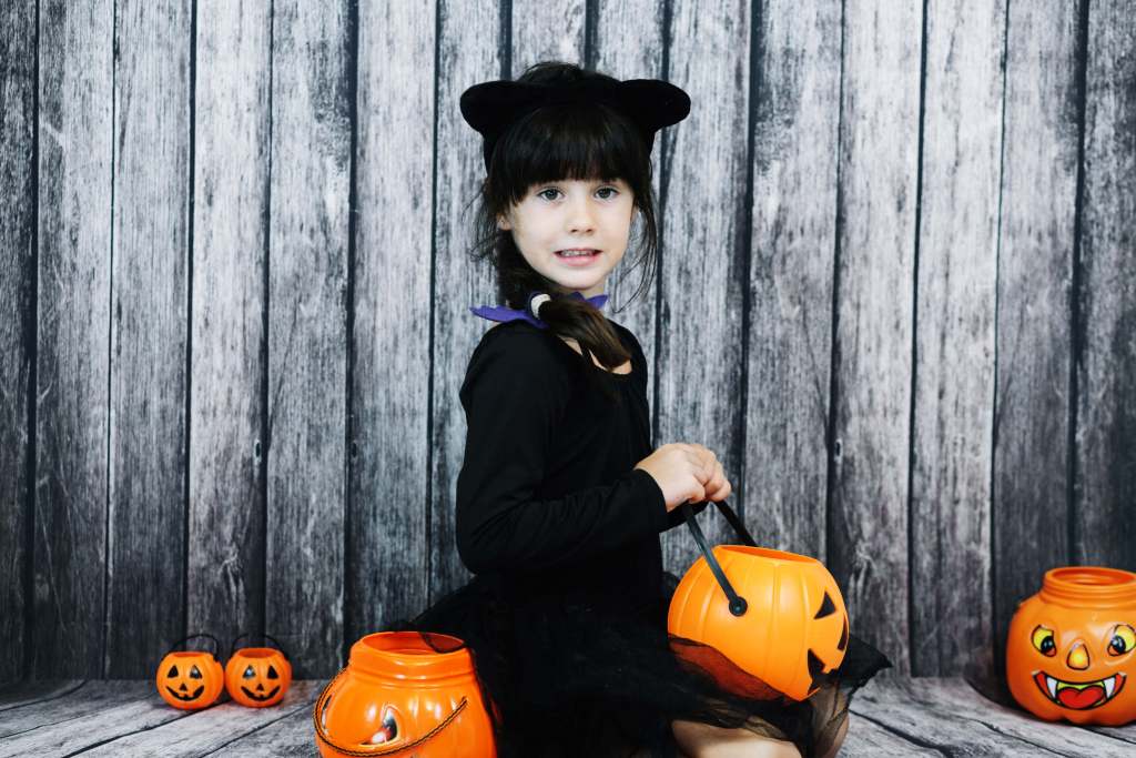 girl-cat-costume-holding-jack-o-lantern-basket