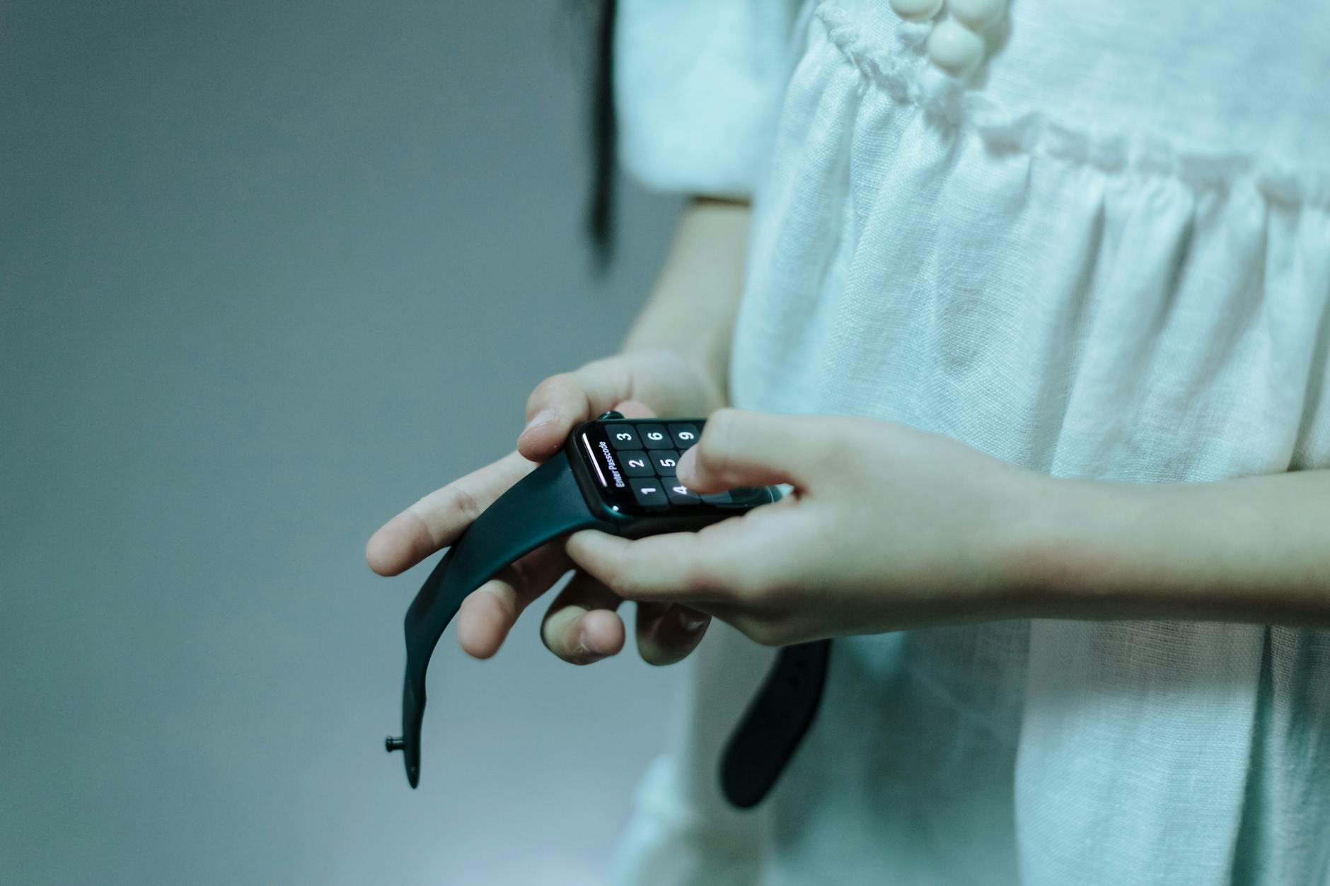 close up of girl holding smartwatch